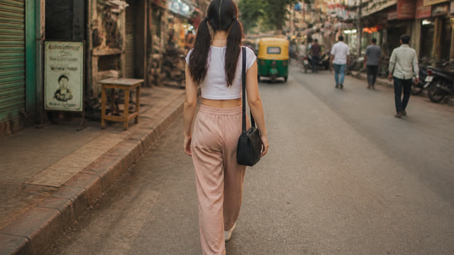 Walking away down a city street — Real style